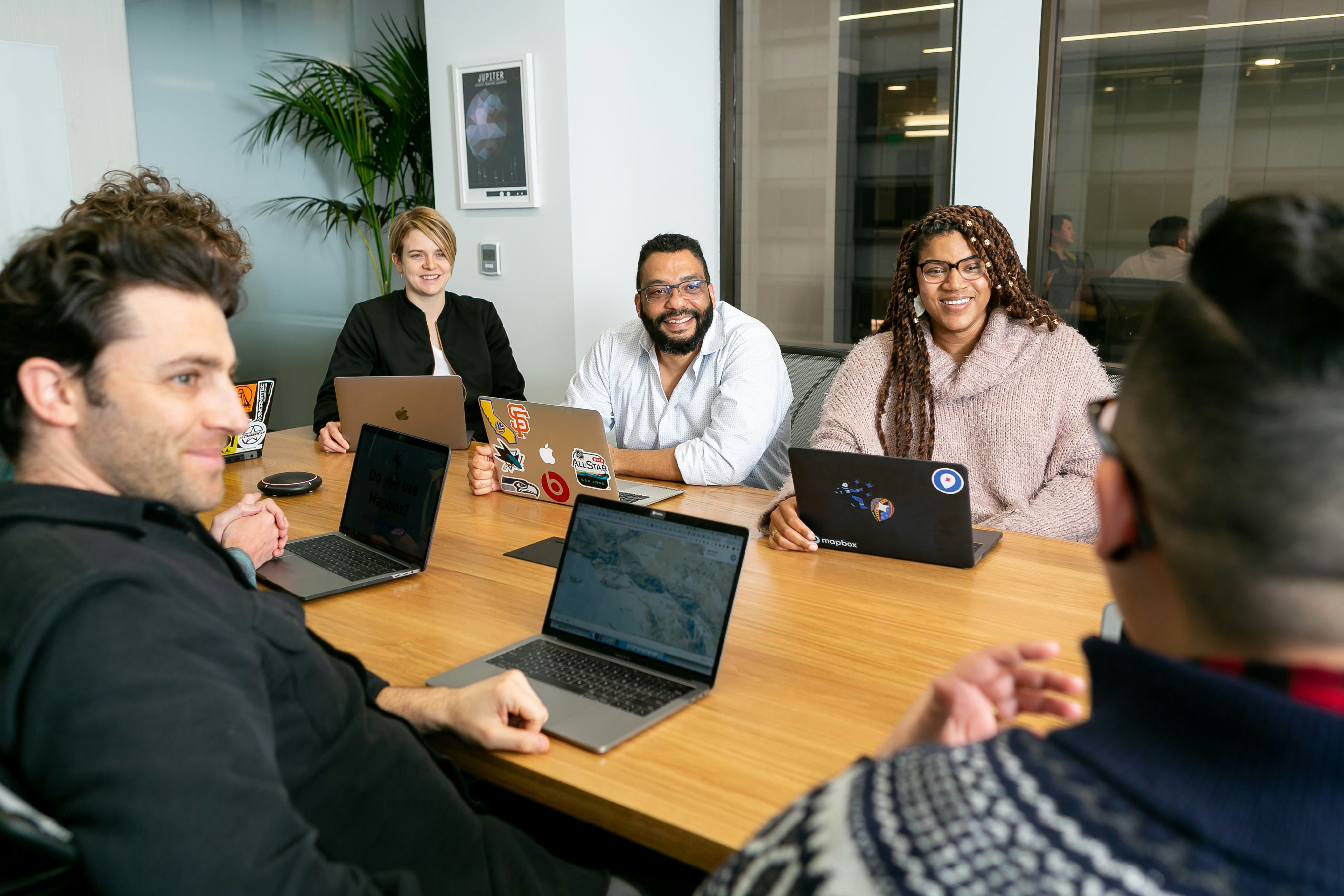An image of three people with computers in an office with the words